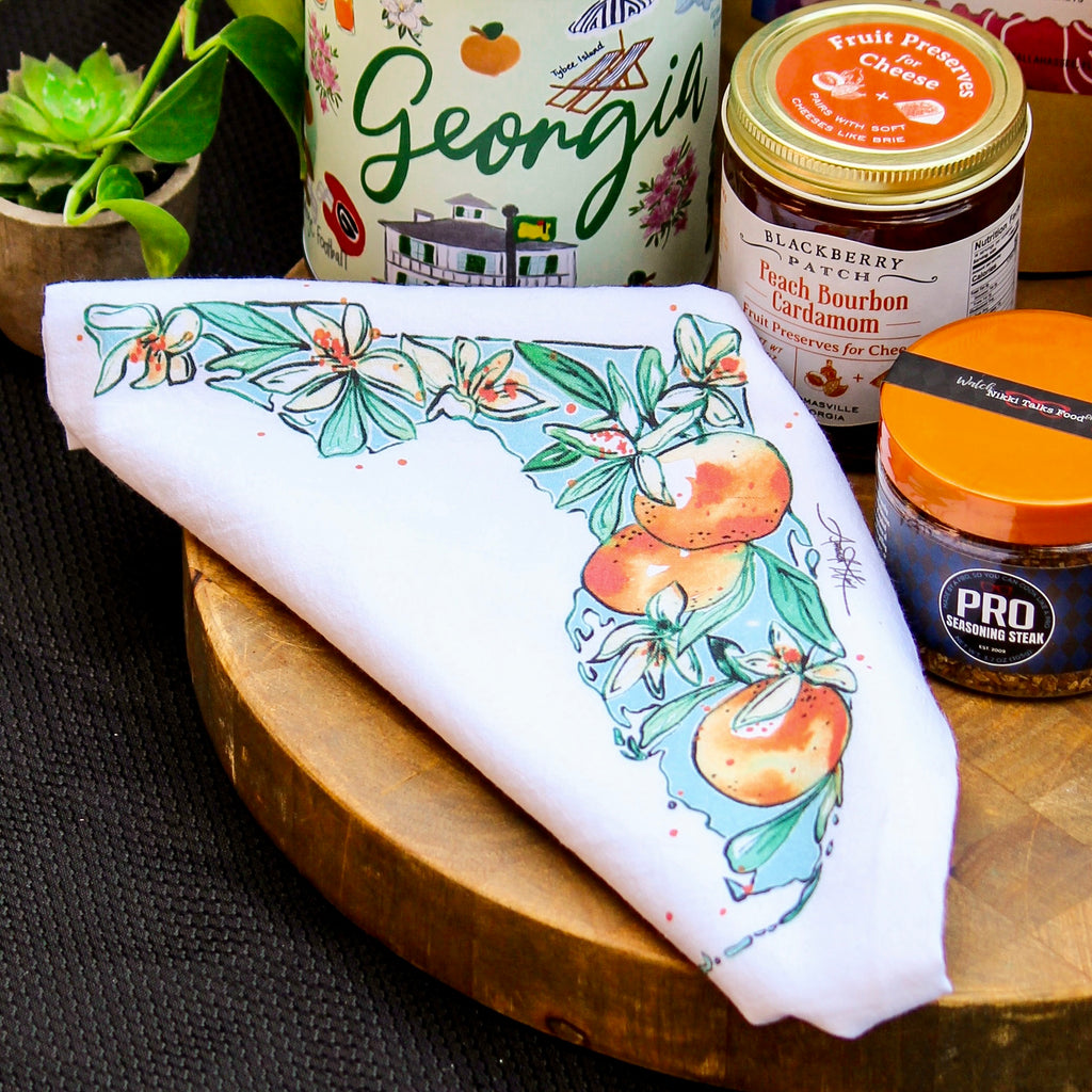 Tally-Thom Gift Set with local foods, coffee, and other gifts sourced from Tallahassee and Thomasville from RedEye Coffee in Tallahassee, FL. This photo shows an Amanda Klein tea towel.